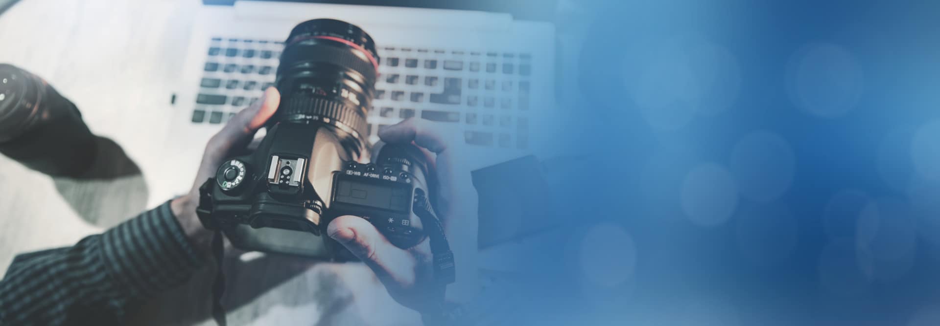 photographer hand camera desk